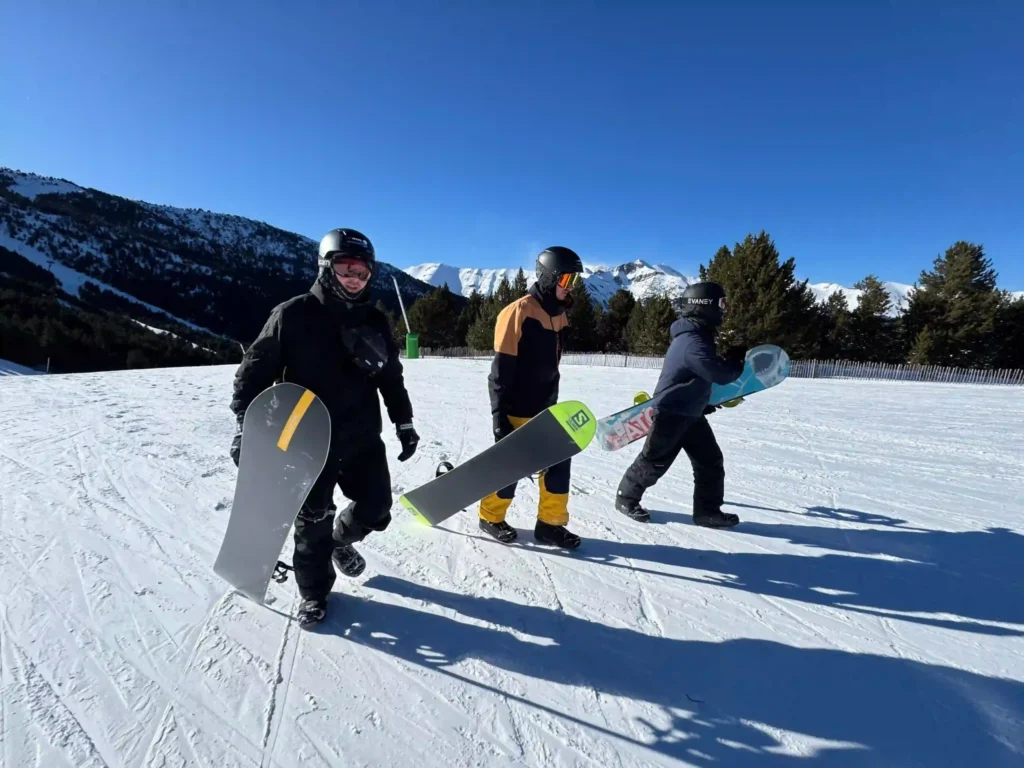 snowboarding
snowboard instructor
3 people walking with snowboards
